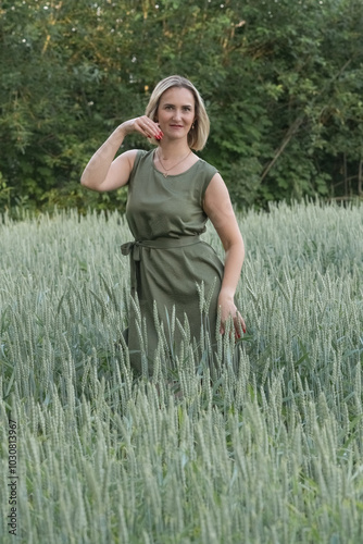 Portrait of a young beautiful blonde girl in a wheat field.