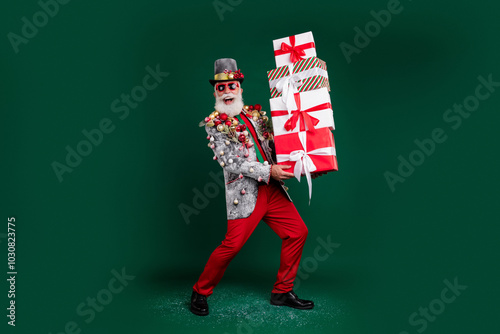 Full size photo of extravagant grandfather christmas gifts decorated outfit isolated on dark green color background