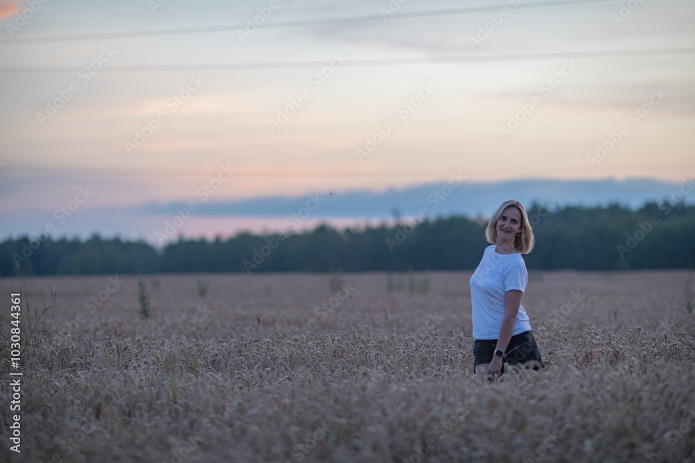 Portrait of a young beautiful blonde girl in a wheat field. Portrait of a young beautiful blonde girl in a wheat field.
