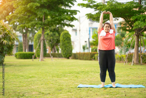 Overweight Asian women practice yoga in the park to strengthen their body and help them lose weight.Young woman is happy to motivation exercise or outdoor in the garden to control or lose weight