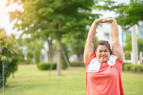 Overweight Asian women practice yoga in the park to strengthen their body and help them lose weight.Young woman is happy to motivation exercise or outdoor in the garden to control or lose weight
