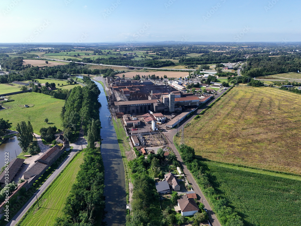 Fototapeta premium Canal de Bourgogne seen from the sky with fields, meadows, a house and a factory