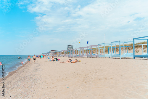 Beautiful beach in Yantarny with blue wooden sun beds and blue sky, Baltic Sea. Yantarny, Kaliningrad Oblast , Russia - 23 June 2024 photo