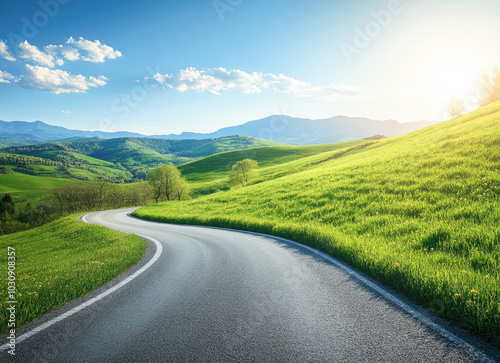 Serene curving road through lush green hills under a clear blue sky