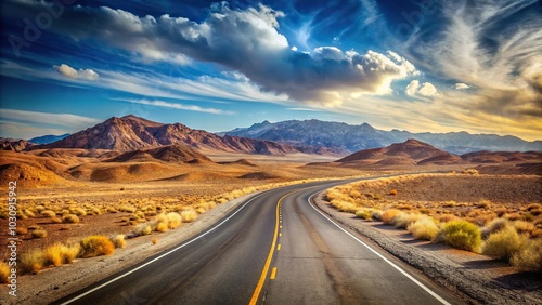 Empty road winding through desert landscape reflected in stock photo