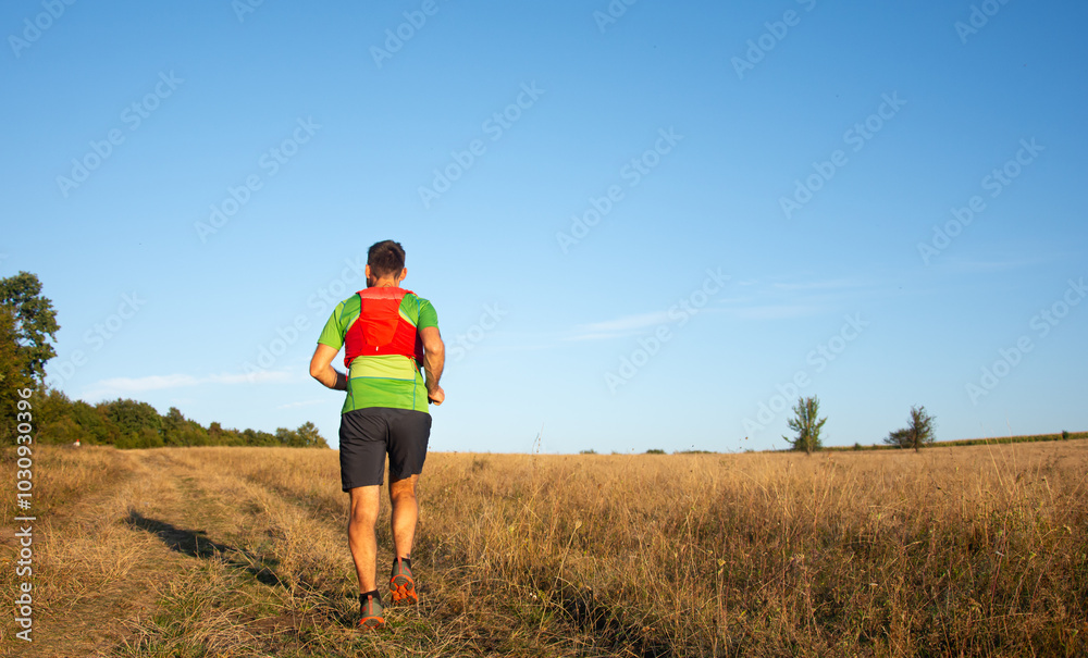 A man Runner of Trail and athlete's feet wearing sports shoes for trail running A man Runner of Trail and athlete's feet wearing sports shoes for trail running
