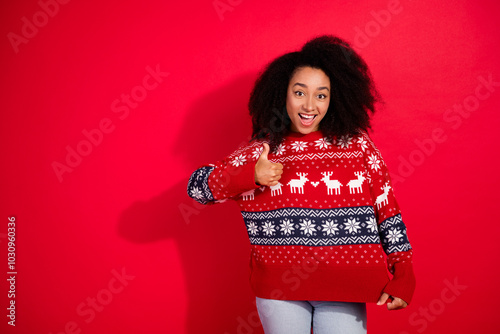 Photo of lovely young lady amazed like sweater ornament dressed stylish christmas garment celebrate winter holidays on red color background photo