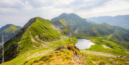 Hiking in Fagaras mountains on Iezerul Caprei peak over Transfagarasan serpentine road carpathian mountains. Mountains landscape. Lake capra photo