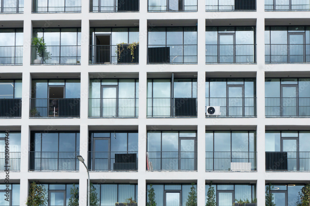 Newly built modern apartment building with glass apartments and balconies. Large windows block of flats. Stylish urban landscape. Futuristic architecture. Newly built modern apartment building with glass apartments and balconies. Large windows block of flats. Stylish urban landscape. Futuristic architecture.