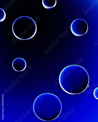 Macro close up of water bubbles with copy space on deep blue background