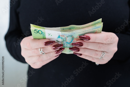 Female hands holding paper bills Belarusian rubles photo