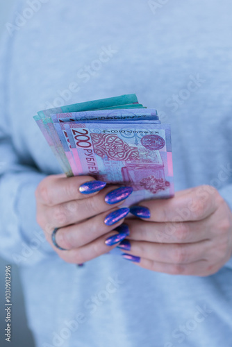 Female hands holding paper bills Belarusian rubles photo