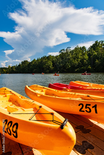 A dock with orange plastic kayaks on the Catawba River, Charlotte, North Carolina photo