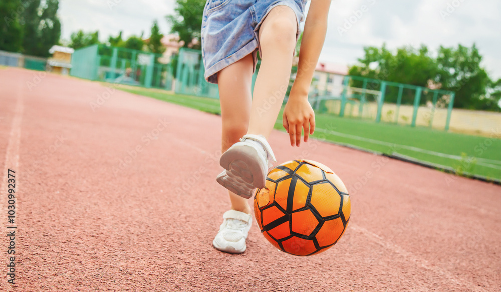 Close up photo young girl playing with ball- dribbling and lifting leg Close up photo young girl playing with ball- dribbling and lifting leg