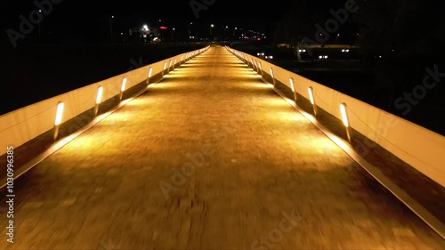 Aerial high angle footage of a 150 years old stone masonry bridge illuminated on a dark night. Drone shot of Master Kolyo Fitcheto's bridge at Byala village over the river of Yantra in Bulgaria.
 photo