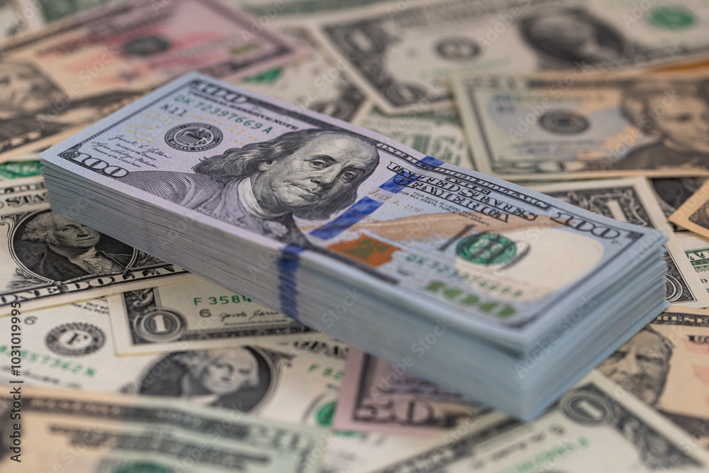 Pile of US 100 dollar banknotes on dollars background Pile of US 100 dollar banknotes on dollars background