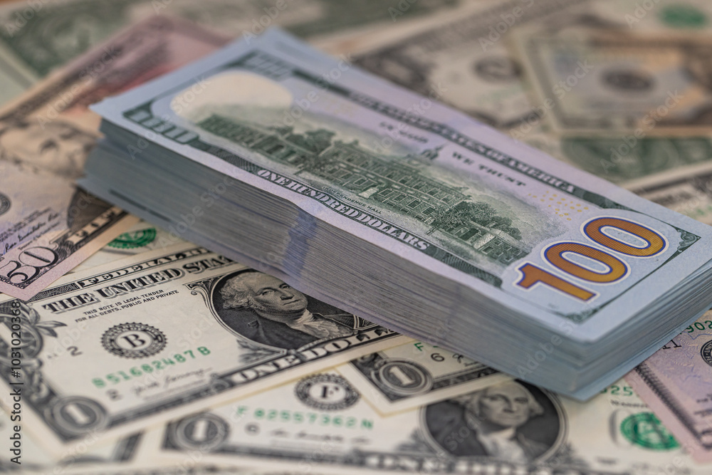 Pile of US 100 dollar banknotes on dollars background Pile of US 100 dollar banknotes on dollars background