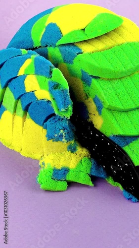 Very Satisfying and Relaxing Kinetic Sand ASMR video. Cutting anti stress macro close up colorful Kinetic Sand with a Knife. ASMR sounds. photo