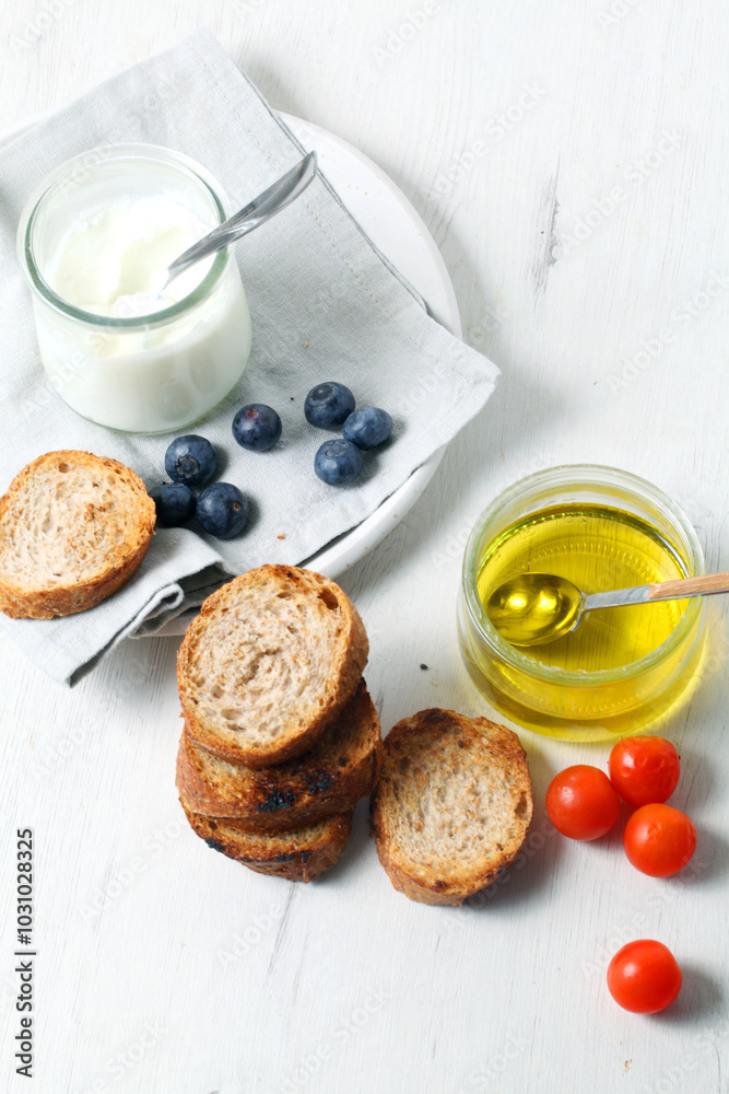 Greek yogurt with slices of toasted whole wheat bread and olive oil Greek yogurt with slices of toasted whole wheat bread and olive oil