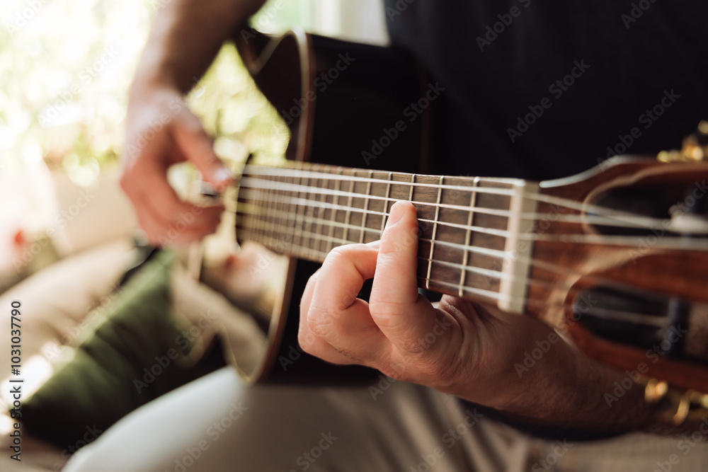 Hands of a person playing an acoustic guitar close up Hands of a person playing an acoustic guitar close up