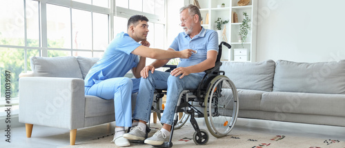Male nurse hearing senior m...