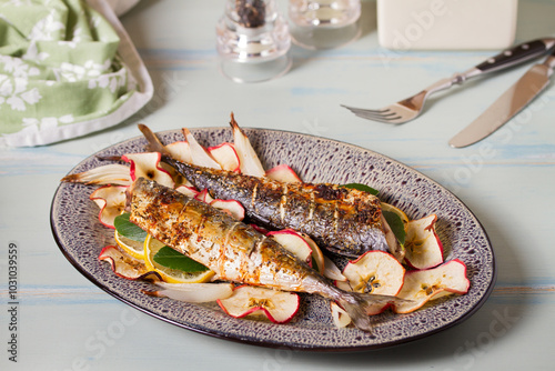 Grilled mackerel with apples, onoions and bay leaves photo