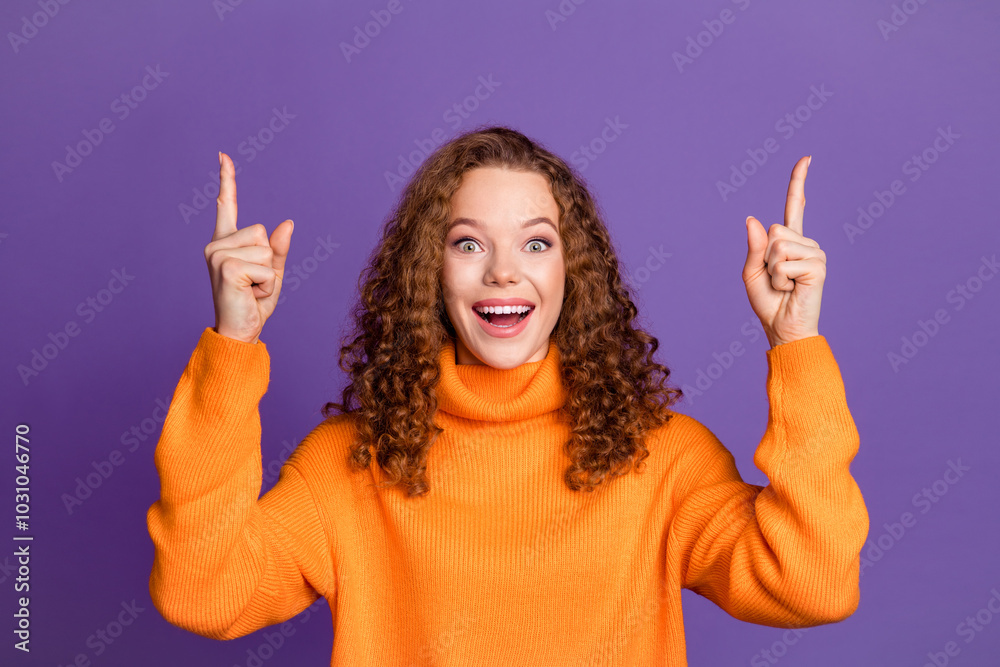 Portrait of nice young girl point fingers up empty space wear pullover isolated on purple color background Portrait of nice young girl point fingers up empty space wear pullover isolated on purple color background