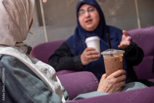 Friends Enjoying Coffee Together in a Cozy Cafe Setting photo