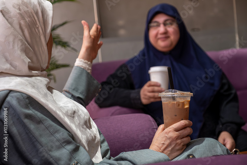 Friends Enjoying Coffee Together in a Cozy Cafe Setting photo