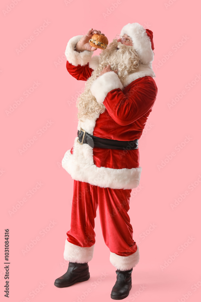 Santa Claus with tasty burger on pink background Santa Claus with tasty burger on pink background