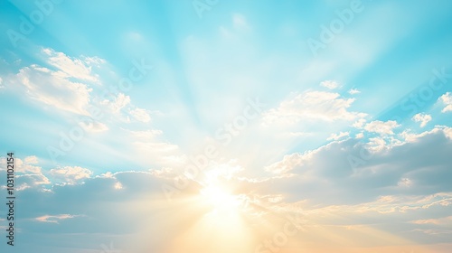 A bright, blue sky with white clouds and sun rays shining through.