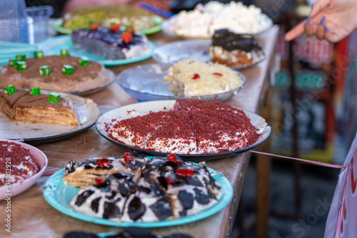 Multiple flavours and types of Crepe Layer Cake (Pancake Cake) with Strawberry, Chocolate, Cookie, Red Velvet, Grape flavors for sale at Jogokariyan Ramadan Night Market, Yogyakarta, Indonesia. photo