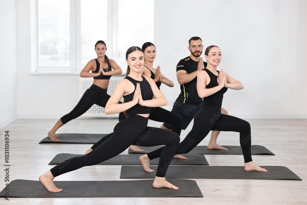 Group of people practicing yoga on mats in class Group of people practicing yoga on mats in class
