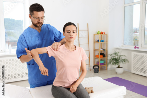 Physiotherapist working with patient in rehabilitation center