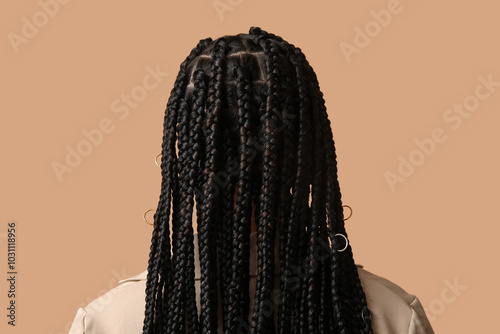 Valokuva Stylish African-American woman with braids on beige background, back view