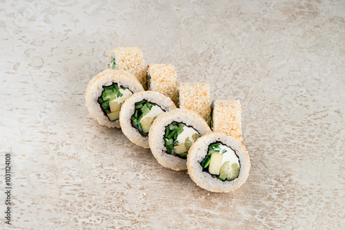 Set of sushi rolls with cucumber, zucchini, cream cheese, rice, nori and sesame seeds. photo