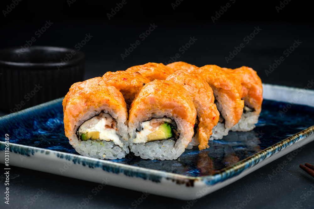 Set of Japanese maki sushi rolls with salmon tartare, smoked eel, cream cheese and avocado. Set of Japanese maki sushi rolls with salmon tartare, smoked eel, cream cheese and avocado.