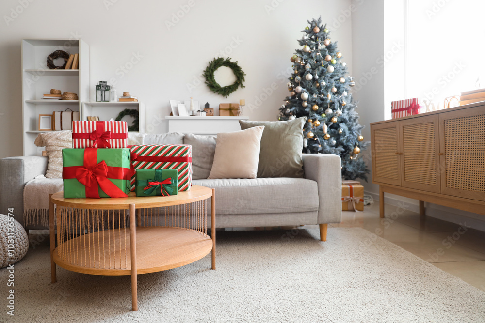Obraz premium Interior of light living room with sofa, Christmas tree and presents on table