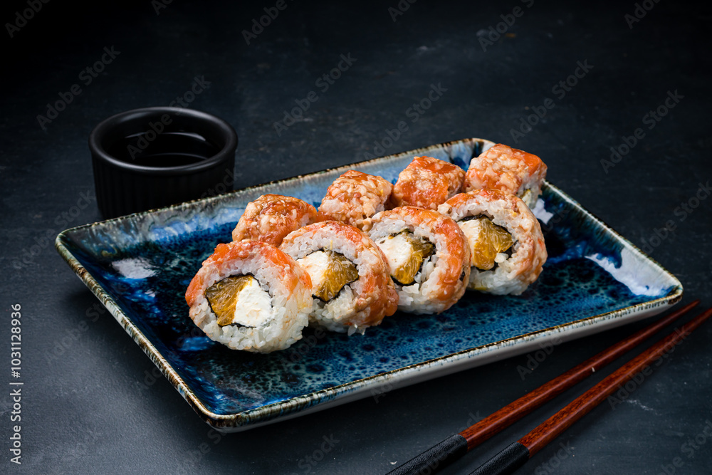 Japanese kitchen set of sushi rolls with salmon, shrimp, cream cheese and orange. Japanese kitchen set of sushi rolls with salmon, shrimp, cream cheese and orange.
