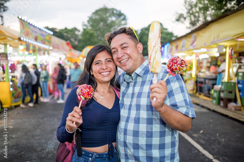 Friends take photos in the middle of the fair, hug each other and show off the snacks they have bought.