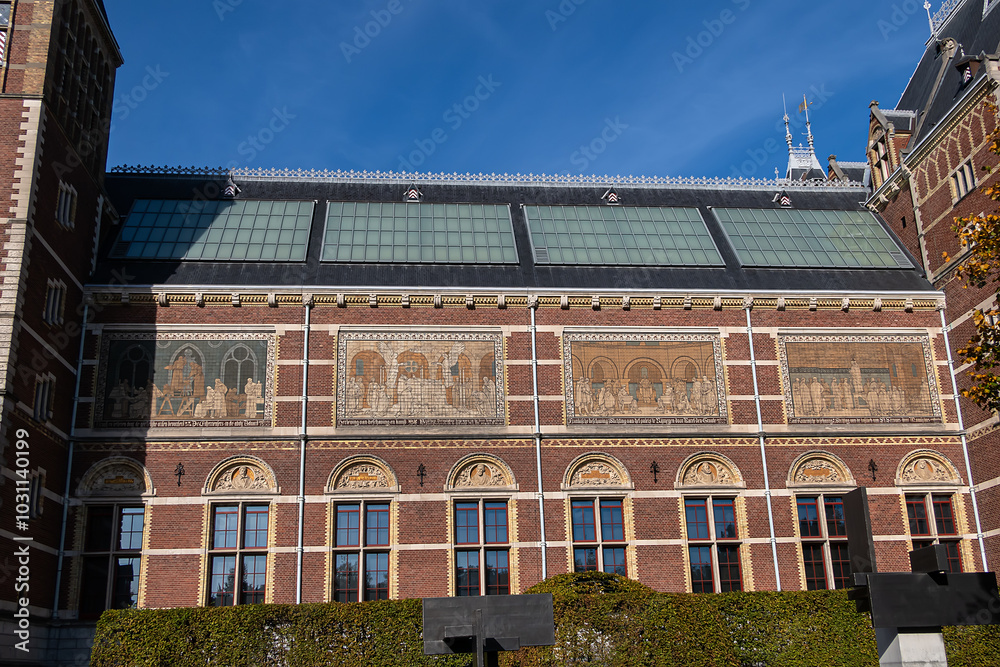 Obraz premium Side of the Rijksmuseum building (1885), seen from the Ruysdaelkade. Amsterdam Rijksmuseum holds many masterpiece paintings of Dutch and world art. Amsterdam, the Netherlands.