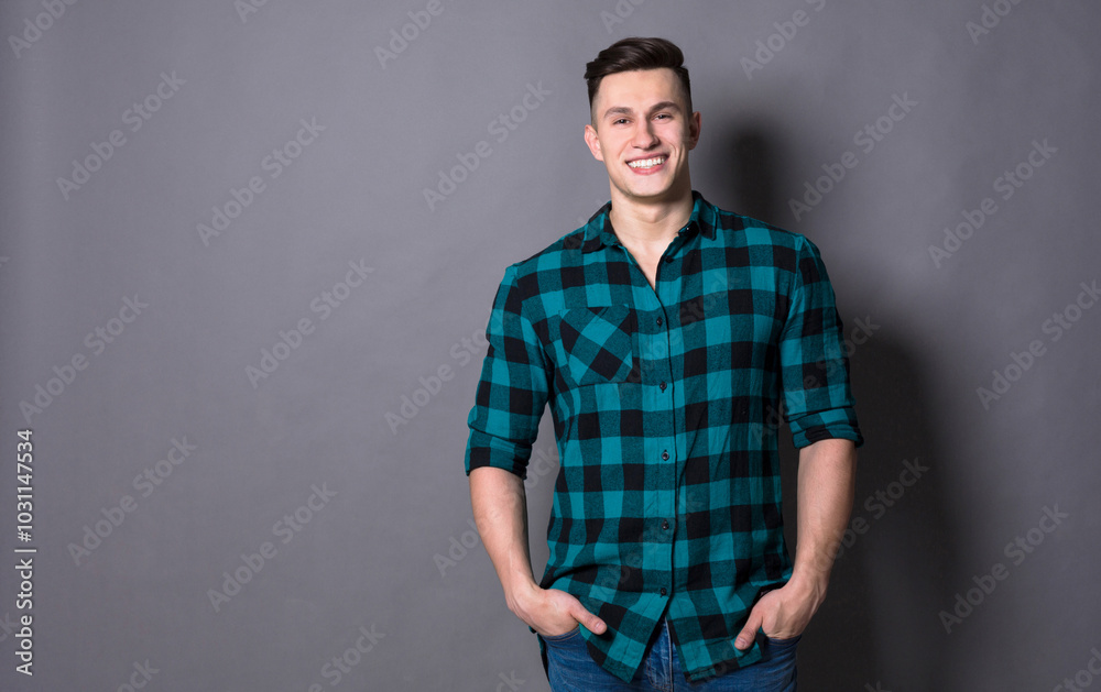 Handsome man model studio portrait. Boy casual style, trendy hipster in checkered shirt look with cool hairstyle Handsome man model studio portrait. Boy casual style, trendy hipster in checkered shirt look with cool hairstyle
