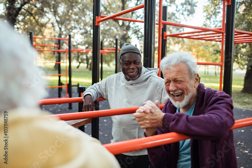 Senior male friends working out at outdoor exercise park photo