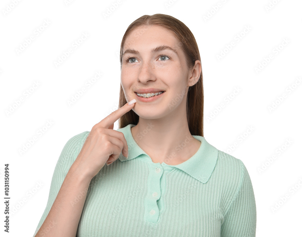 Smiling girl pointing at her braces on white background Smiling girl pointing at her braces on white background
