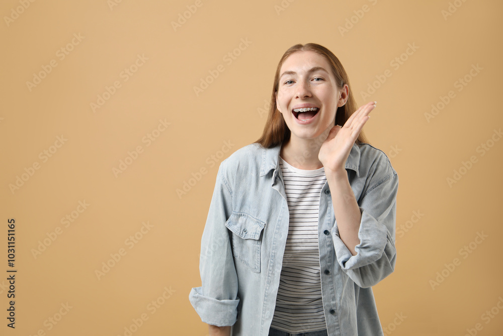 Smiling girl with braces on beige background, space for text Smiling girl with braces on beige background, space for text