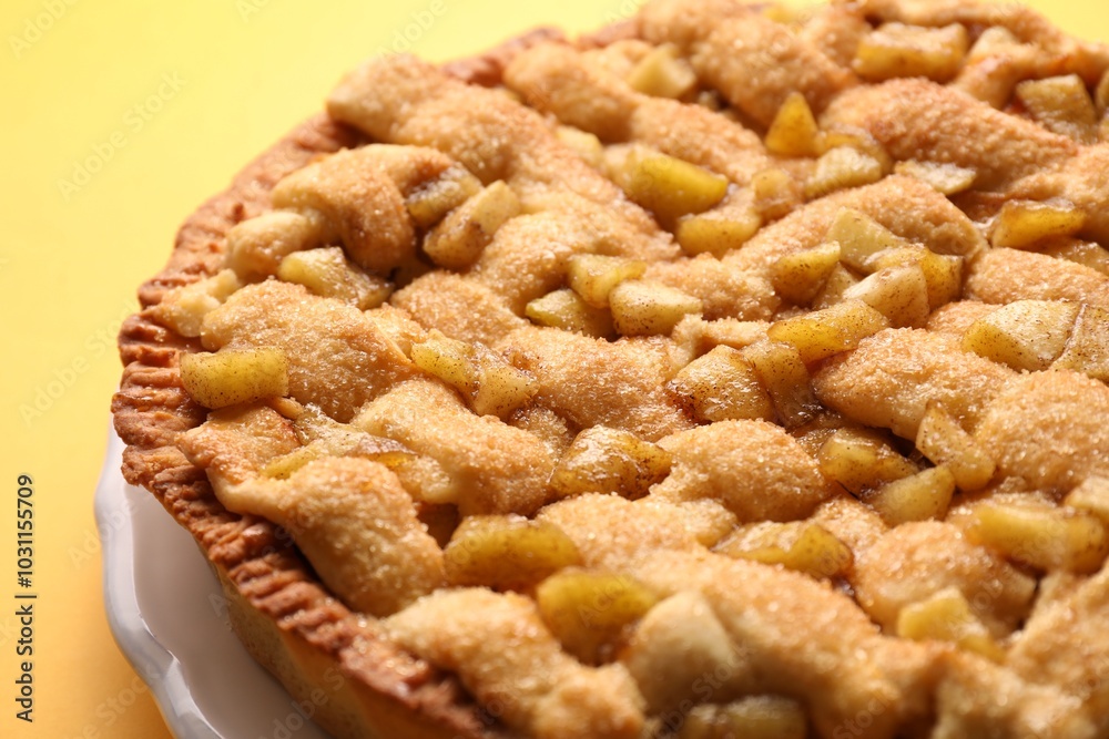 Tasty homemade apple pie on yellow background, closeup Tasty homemade apple pie on yellow background, closeup