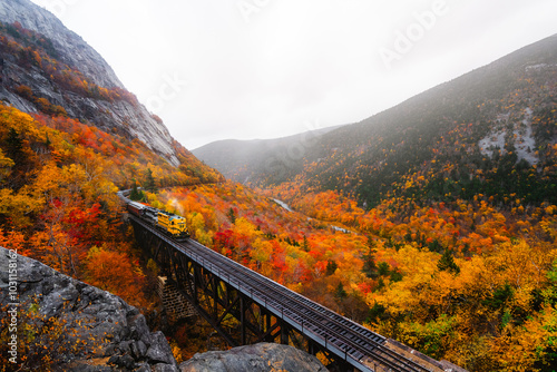 North Conway, New Hampshire - October 14, 2021: Upcoming Train With Steam Smoke Conway on Tracks Fall Foliage Scenic New England. Mount Washington