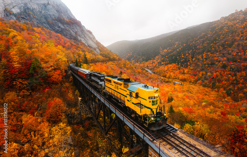 North Conway, New Hampshire - October 14, 2021: Famous Conway Train Touring New England Scenic Ride on Tracks Fall Foliage. Colorful Forest Trees