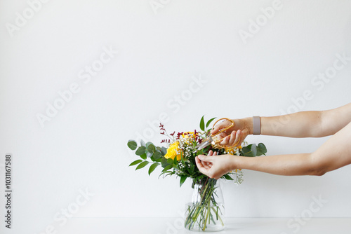 Canvas Print Florist Is Using Gold Scissors To Trim Stems Of A Flower Yellow Roses And Eucaly