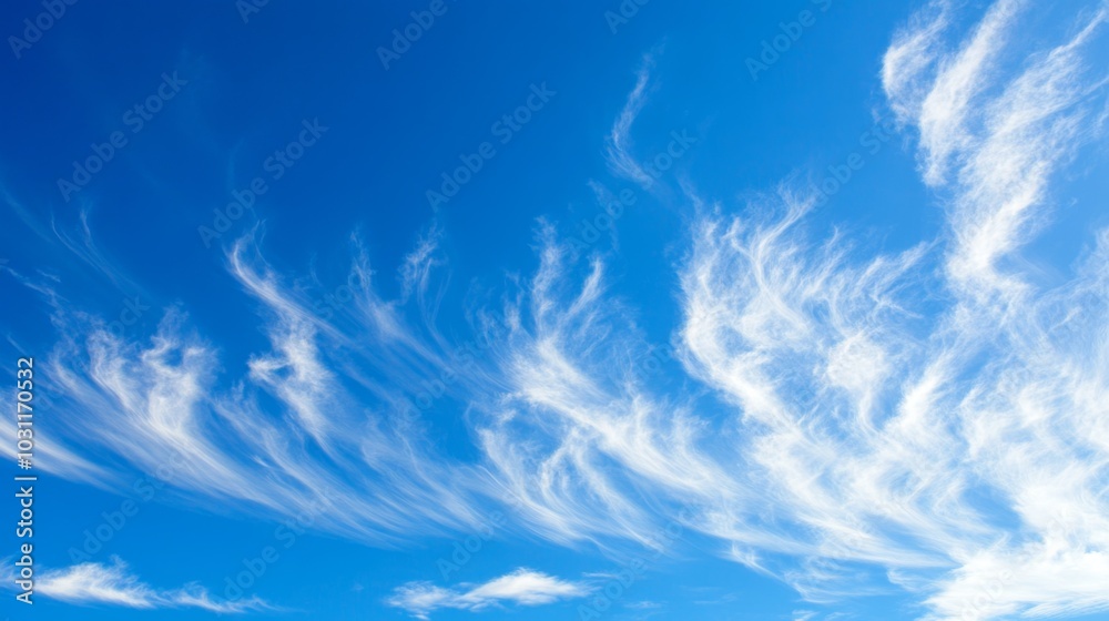 clear blue sky adorned with wispy white clouds, creating a serene and tranquil atmosphere.